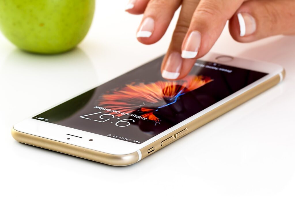 an image showing the hand of a woman tapping on the smartphone 