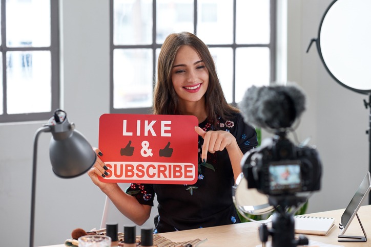 Social media influencer asking followers to like and subscribe
