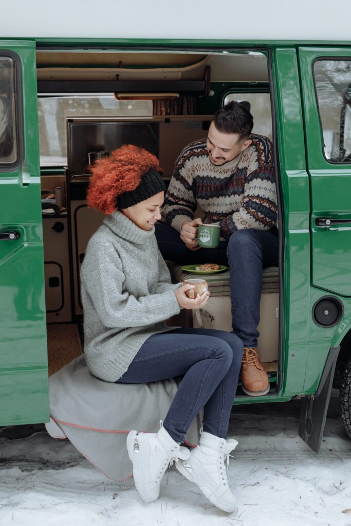 A couple enjoying breakfast in a large vehicle