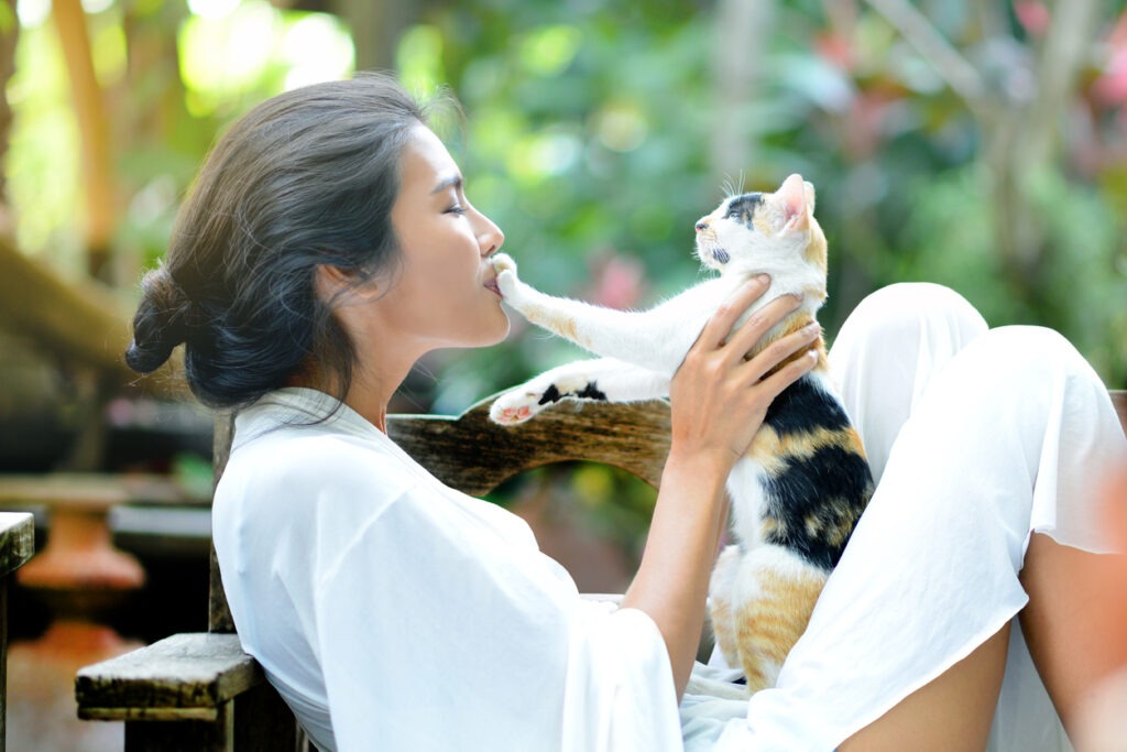 A young woman bonding with a cat