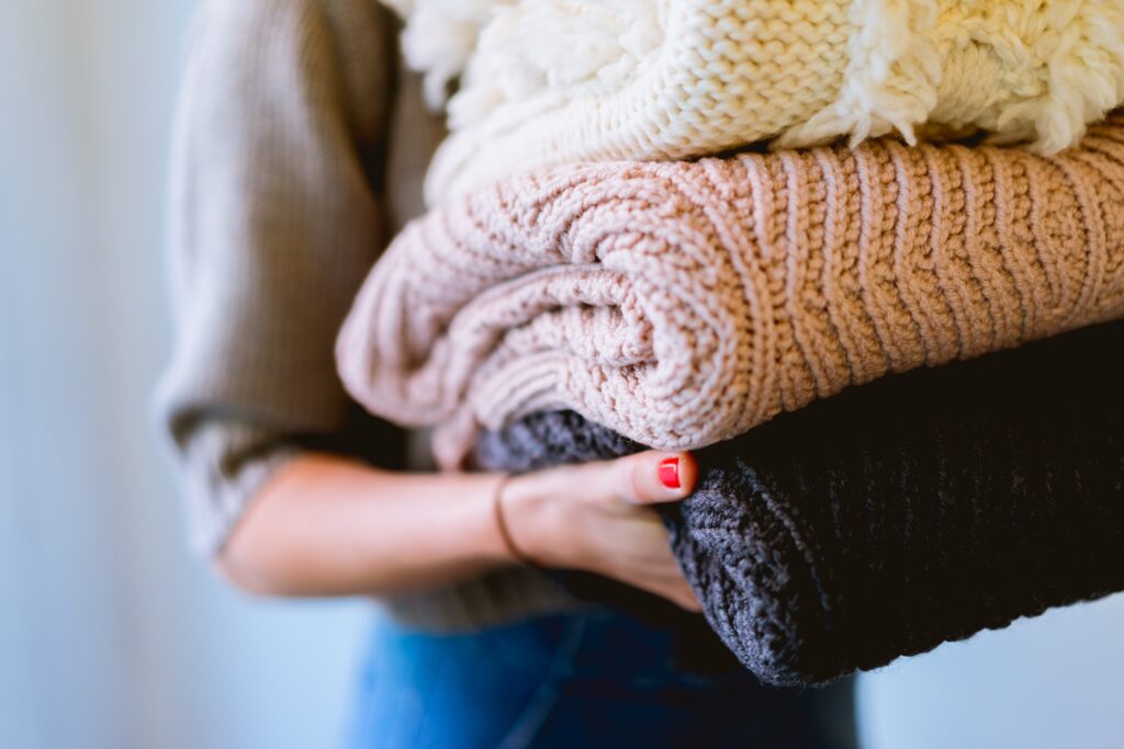 An image of a person holding knitted textiles