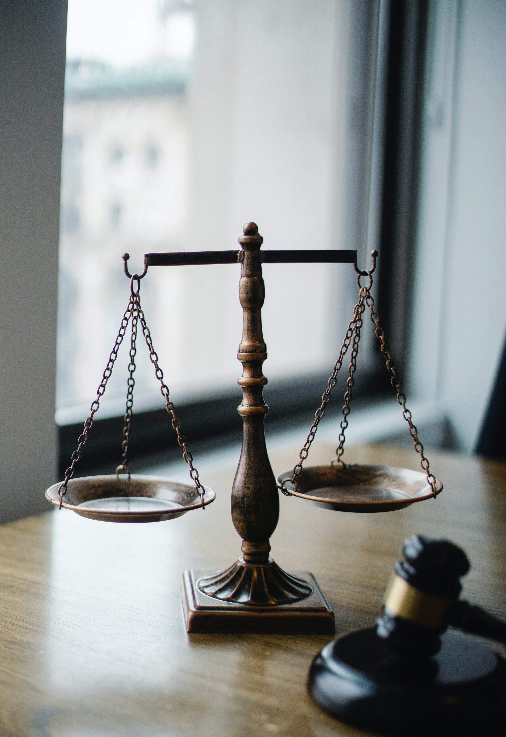A judgment scale and a gavel in a judge’s office image