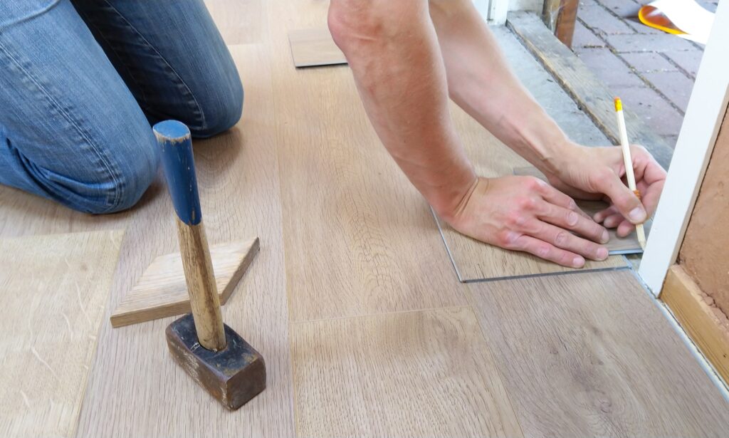 Person holding pencil while working on the floor image