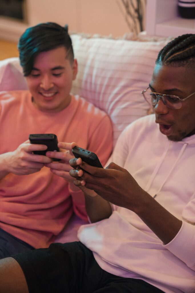 Happy Guys Sitting on Couch Playing Video Games