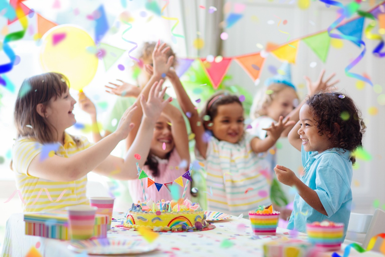 Group of children enjoying and playing ring around the rosy on a birthday party
