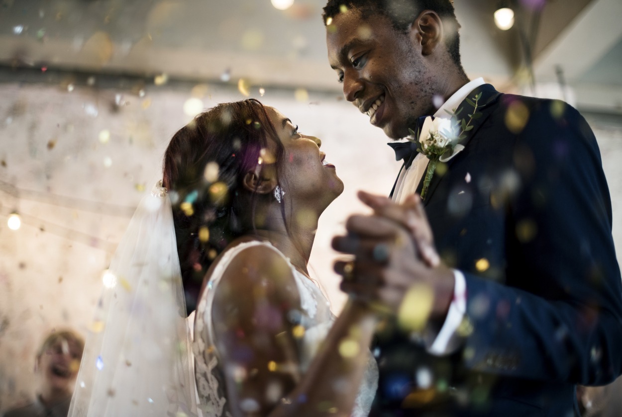 Newlywed African descent couple dancing wedding celebration