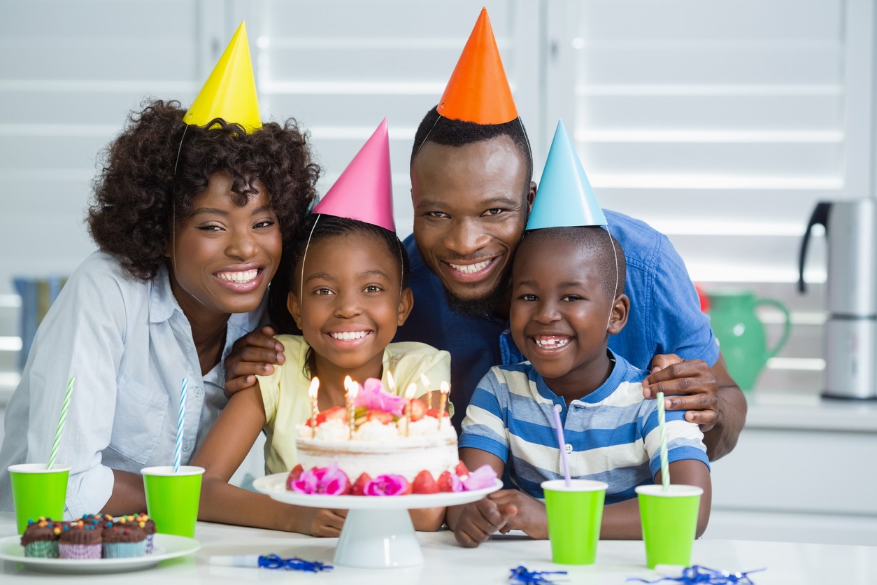 Portrait of happy family celebrating birthday party at home