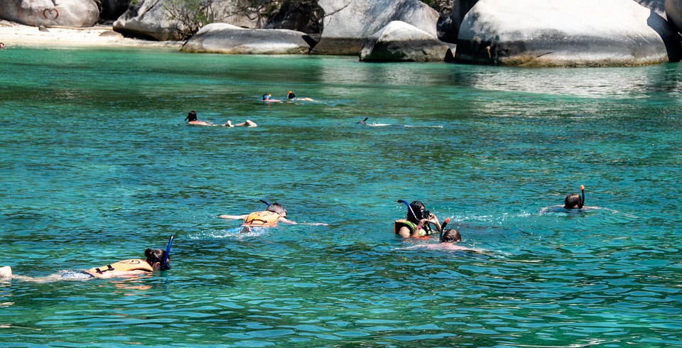 family snorkeling in shallow waters 