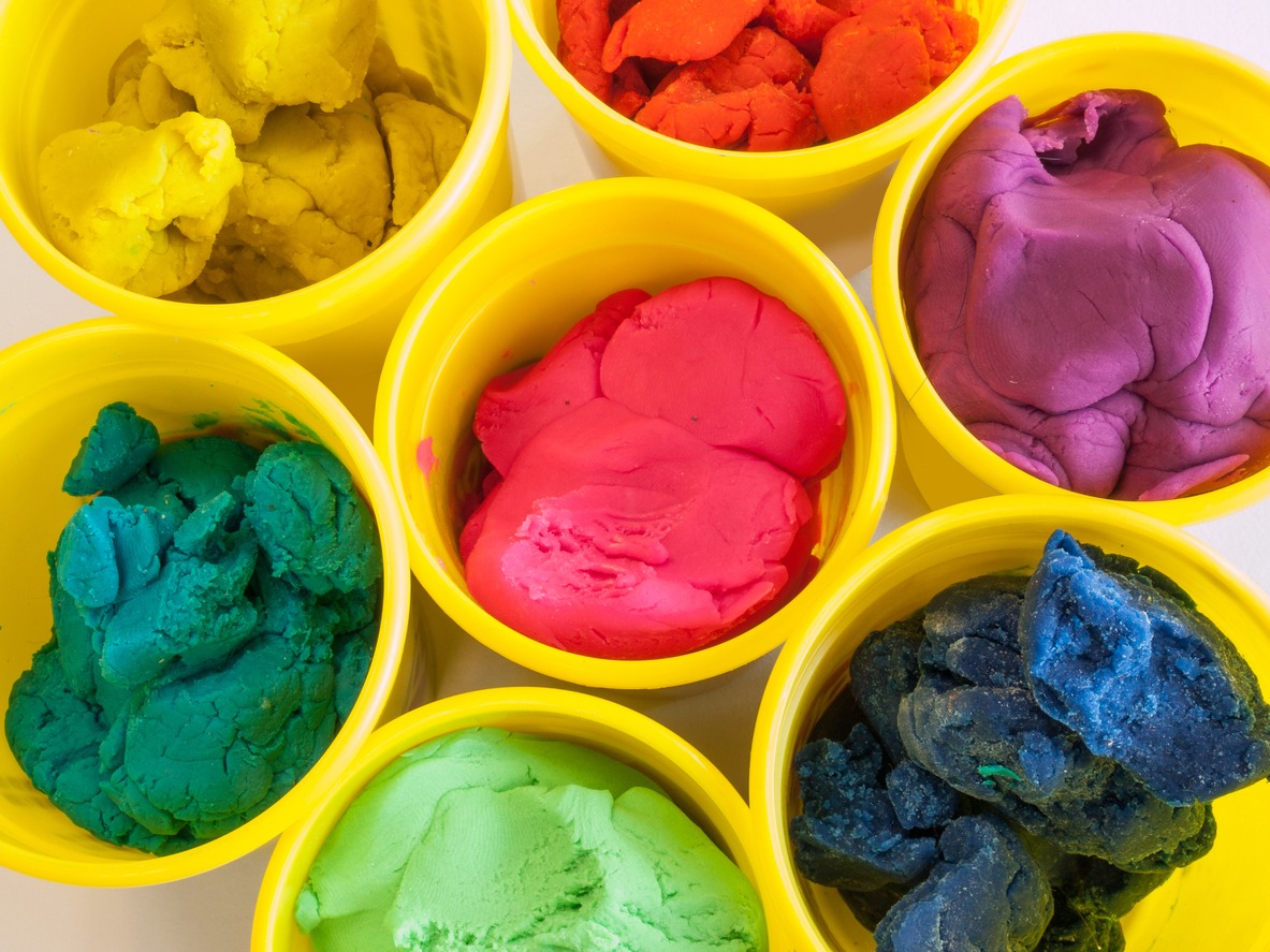 colorful play dough in yellow cans