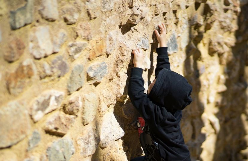A boy climbing the walls