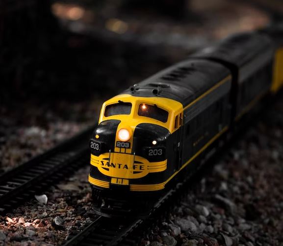 Yellow model train on track