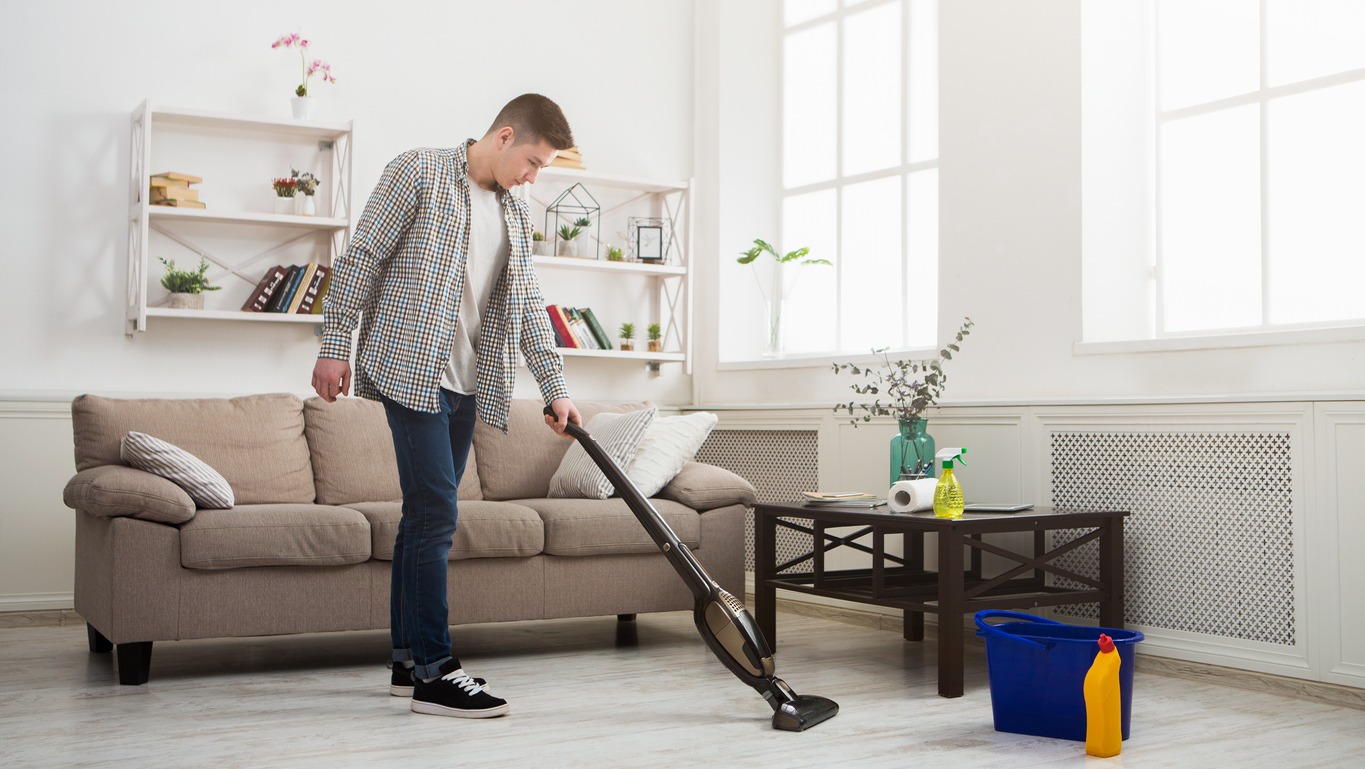A-man-using-a-vacuum-cleaner