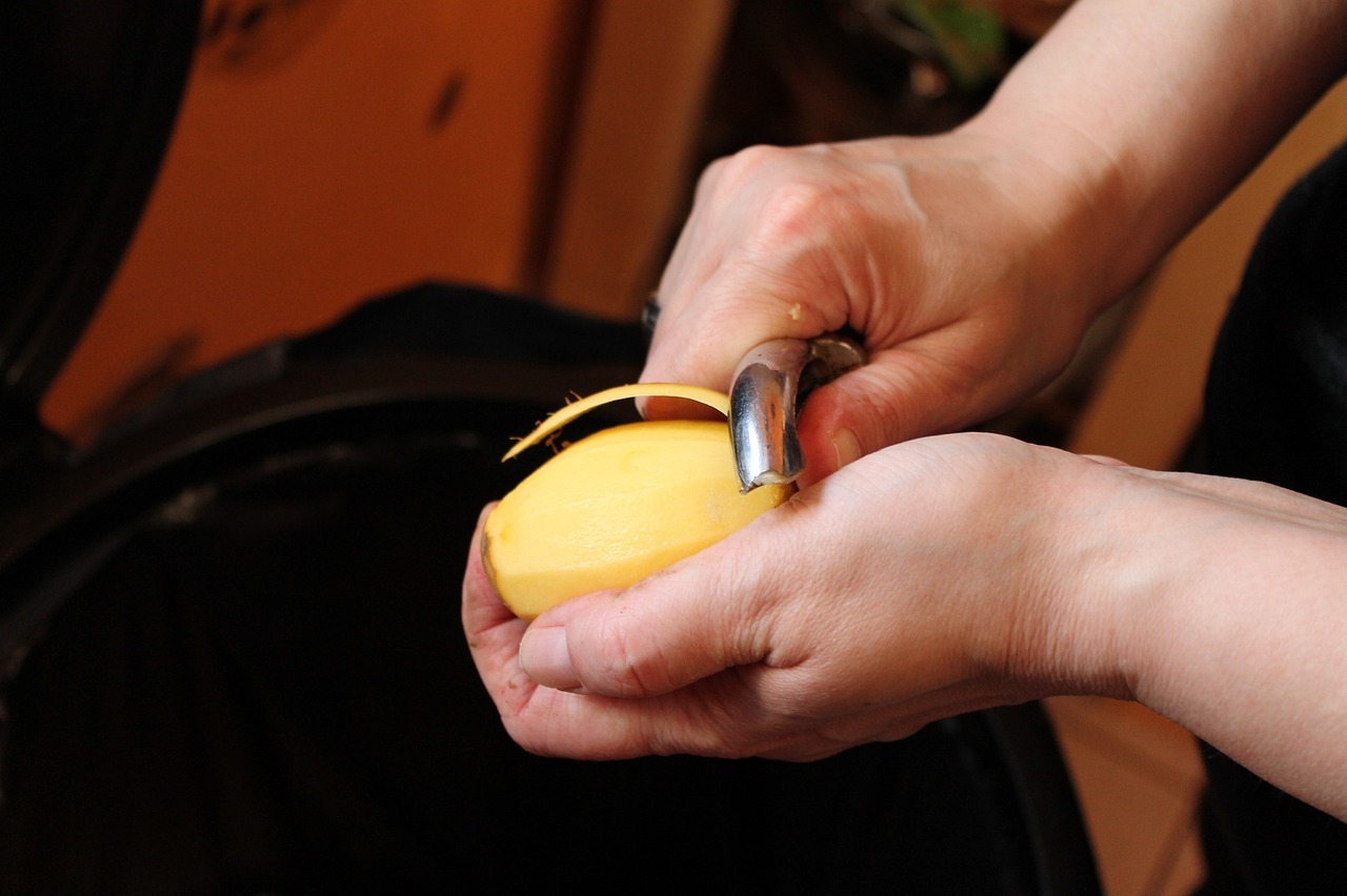 picture of a person peeling a potato