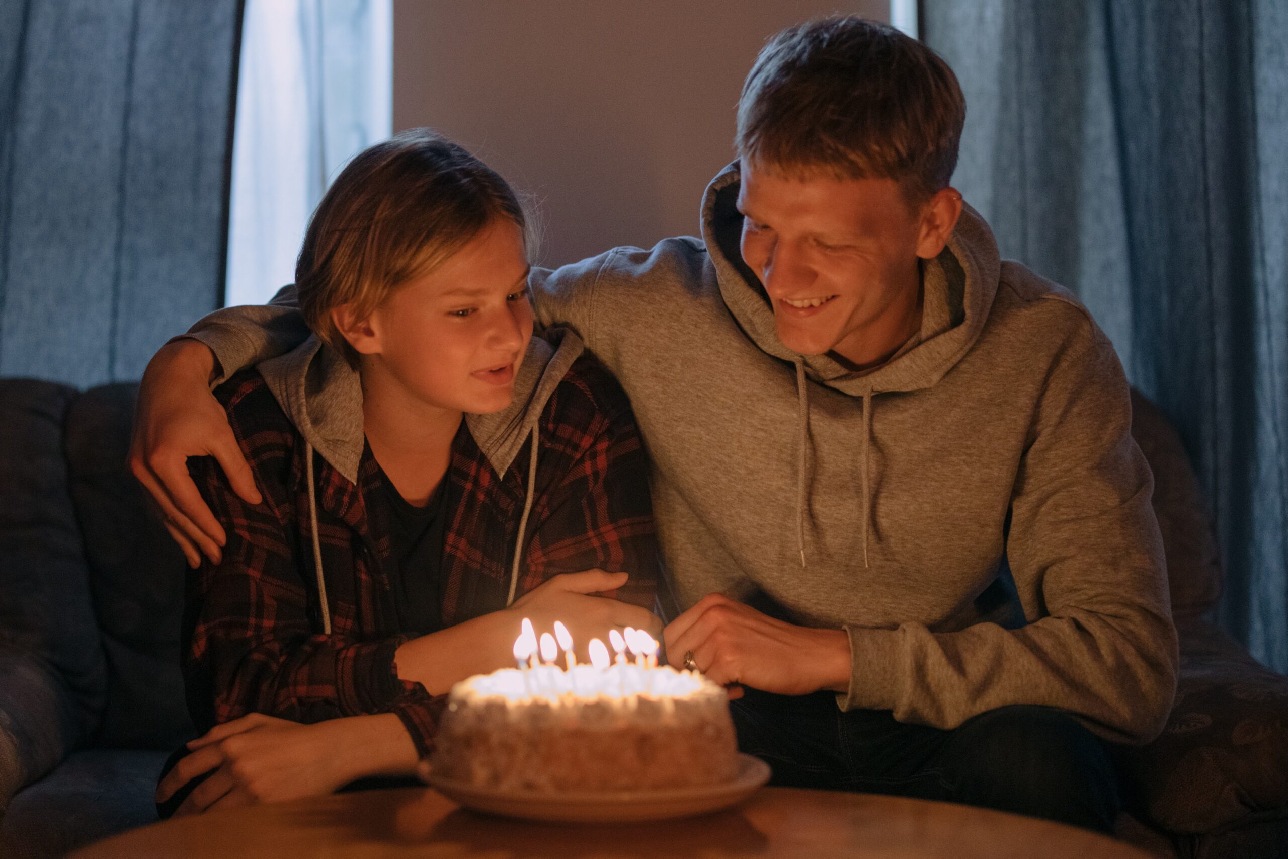 A boy and a man in front of a birthday cake