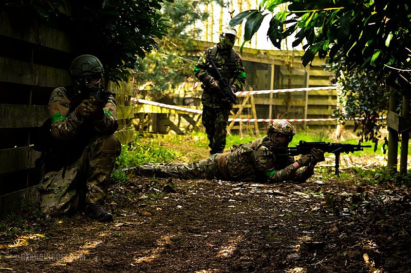 Airsoft-players-in-action-as-they-protect-a-subject.