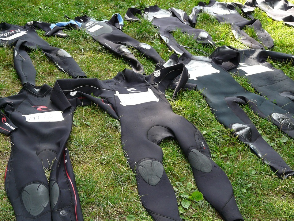 Wetsuits-lying-on-the-grass