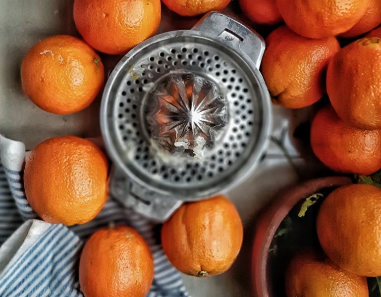 a-citrus-reamer-surrounded-by-oranges