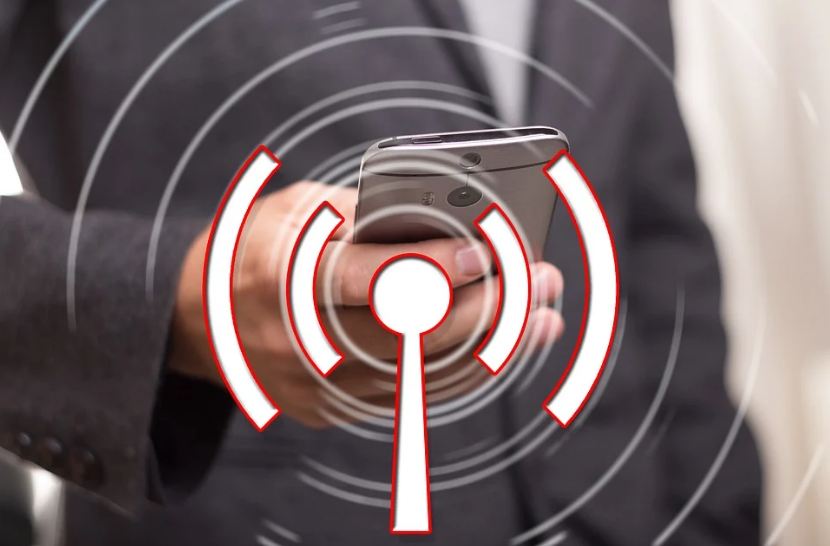 man-holding-phone-with-connectivity-signal-logo-at-the-center