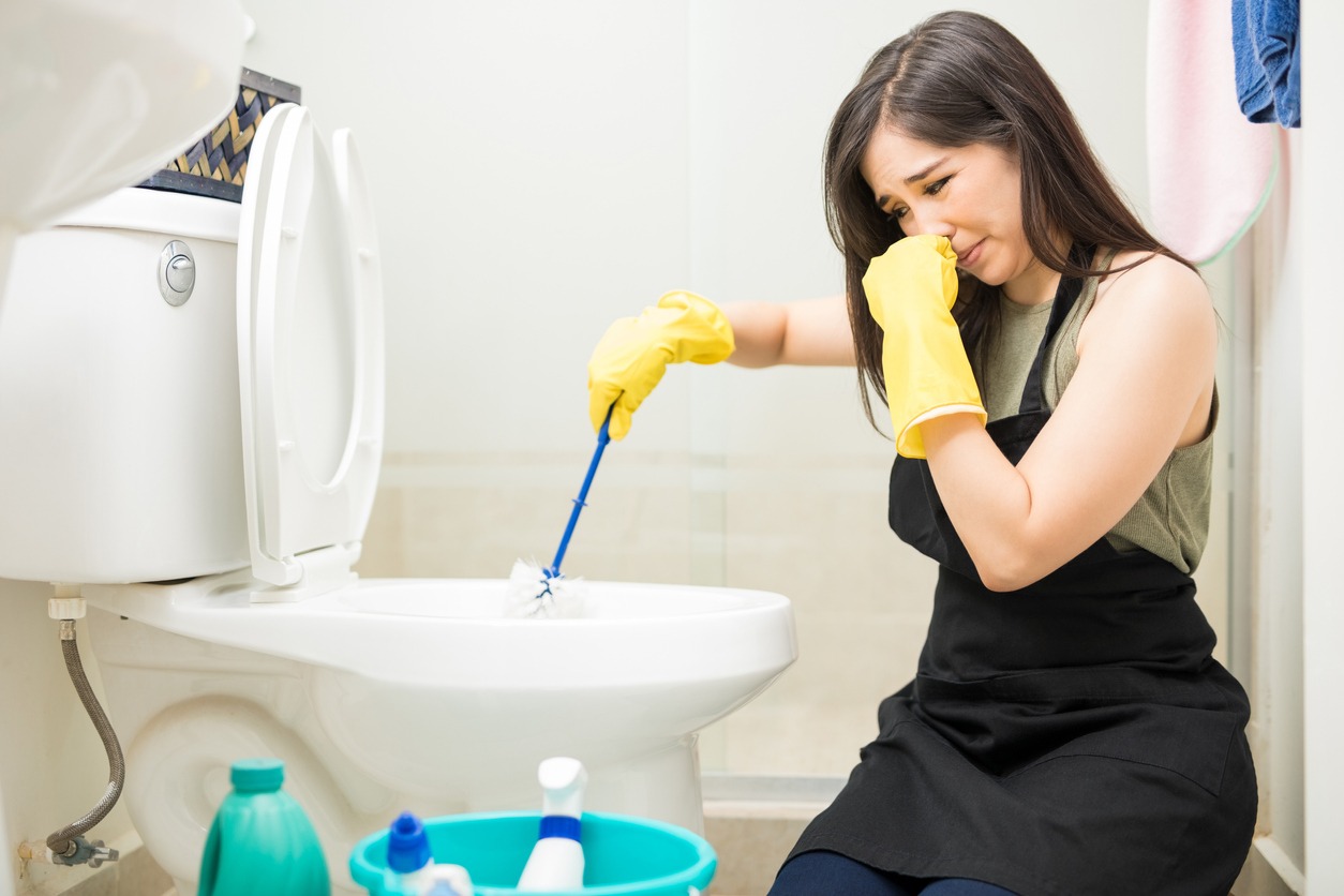 woman-with-rubber-glove-is-cleaning-toilet